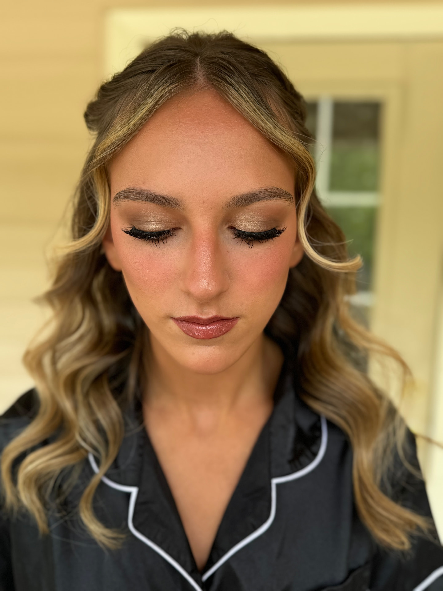 Gold shimmer eyeshadow with winged liner and dewy finish