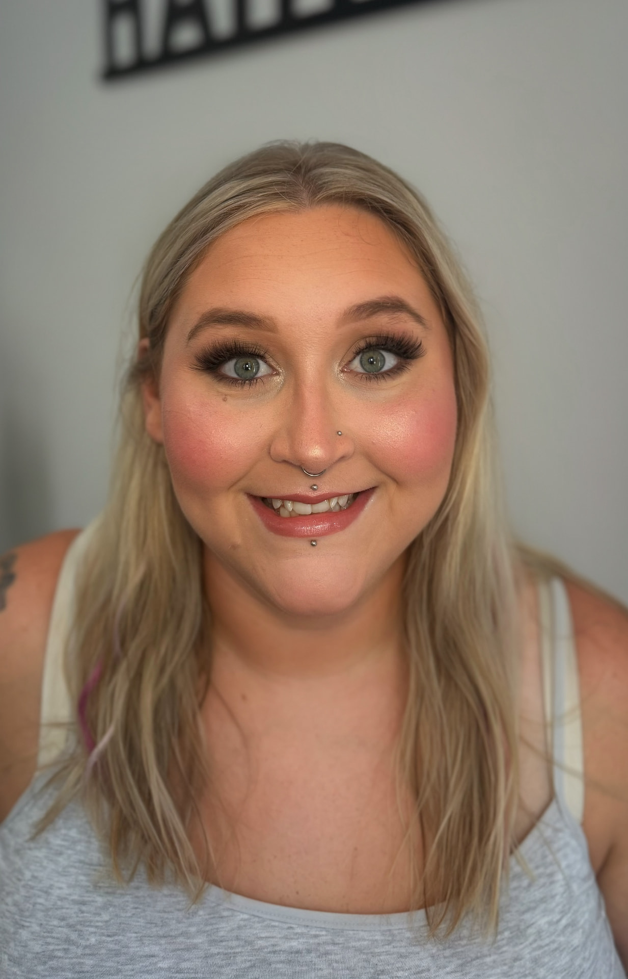 Bright blush glam with full lashes and glossy nude lip