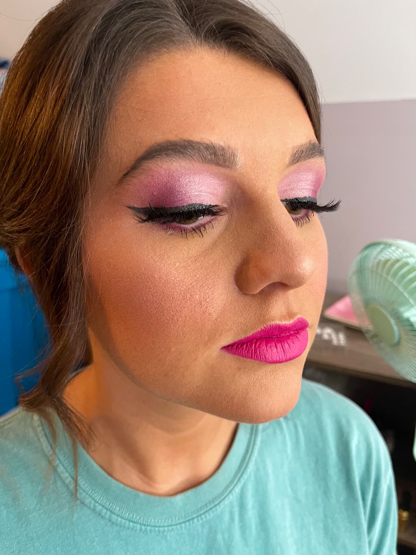 Bold pink shimmer eyeshadow with graphic liner and hot pink matte lip